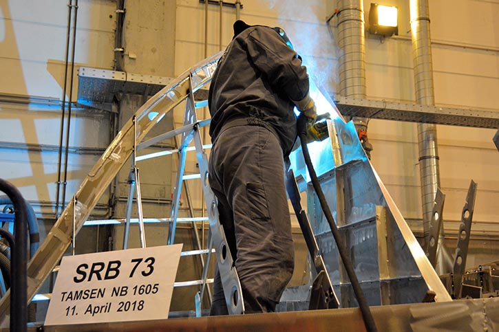 Ein Werftarbeiter schweißt am Seenotrettungsboot SRB 73 die Kieltasche zu.